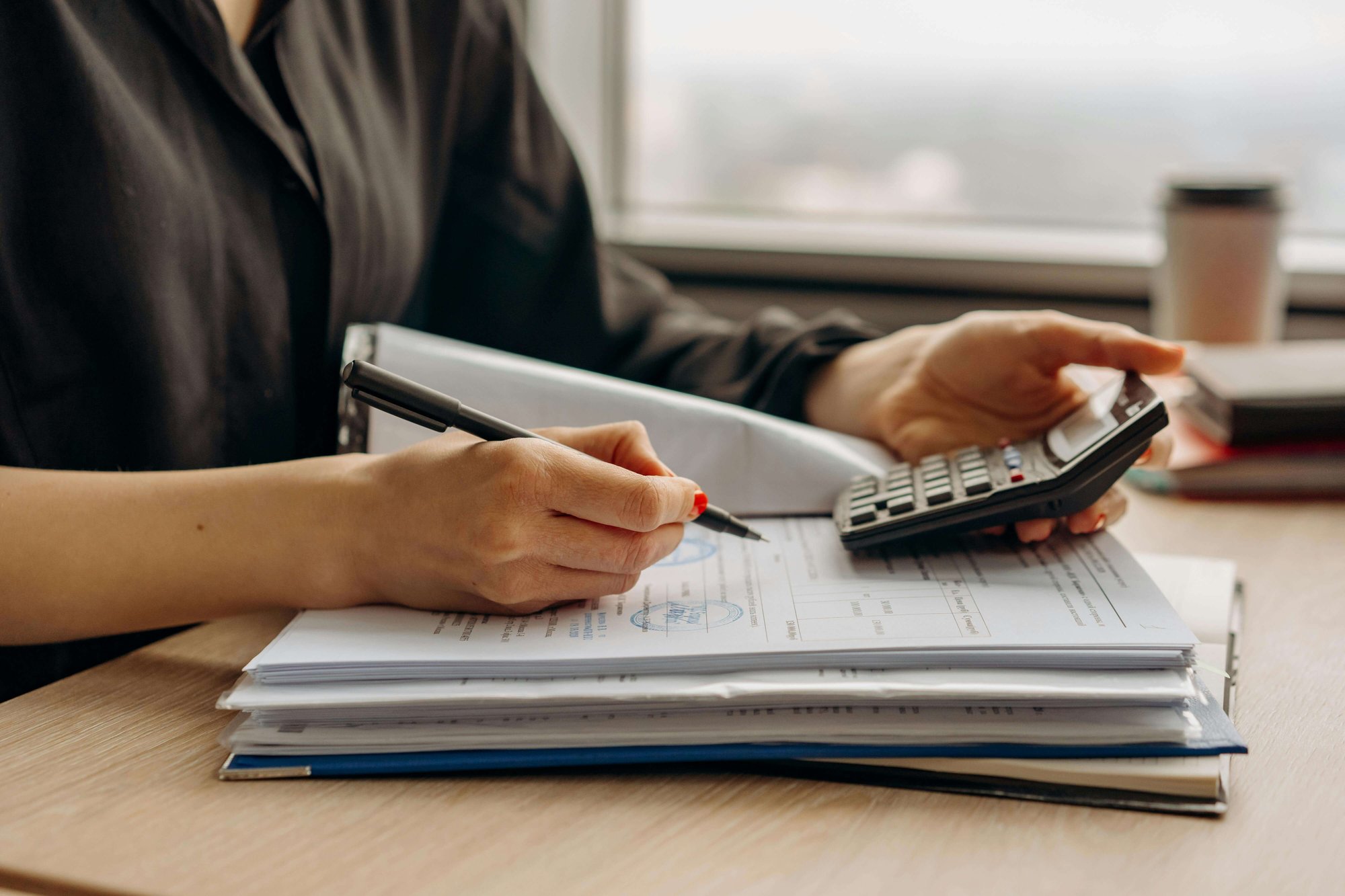 Lady with calculator and documents