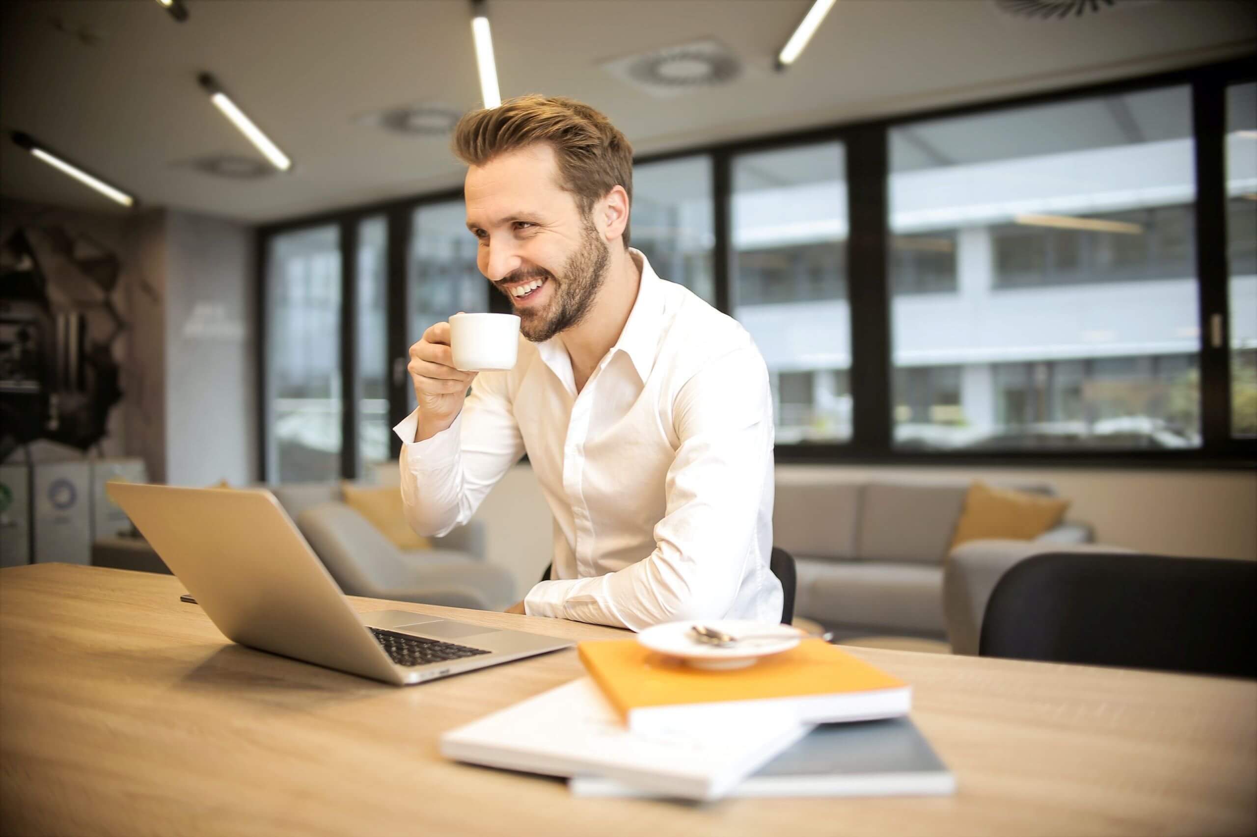 Man drinking coffee at desk
